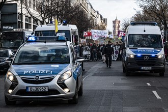 Police cars at the edge of the demonstration