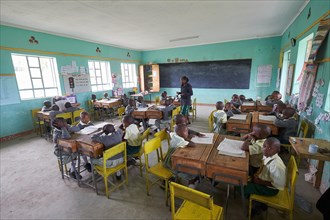 Students with a teacher in the classroom during lessons at the Primary School