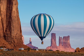 A hot air balloon flying in front of the Utah Monuments