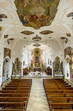 Baroque nave with high altar and mirror vault with ceiling frescoes