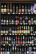 Shelf with assortment of Belgian beer in a beverage shop