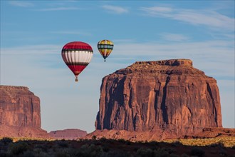 Two hot air balloons fly over Merrick Butte