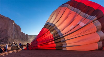 A ground crew inflates a hot balloon in preparation for launch