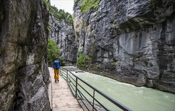 Young man hiking in the Aare gorge in the Haslital
