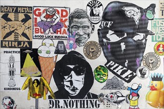 Wall covered with many paste-ups