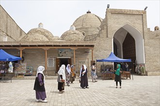 Women in traditional costume at the entrance to the domed bazaars