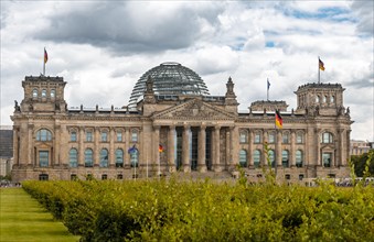 German flag flying next to the Reichstag or German parliament building