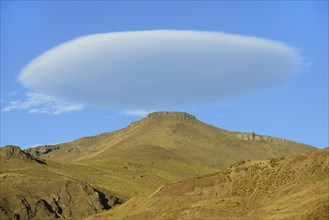 Lenticular cloud over bare mountain