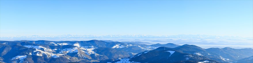 View from the summit of the Belchen to snow-covered mountain and alpine ranges