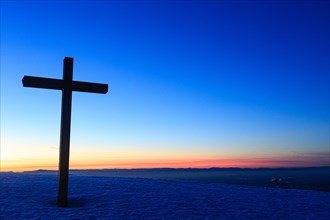 Summit cross of the Belchen with sunset after sunset