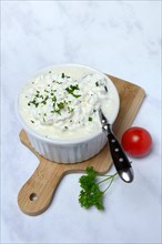 Cream cheese with parsley in bowl