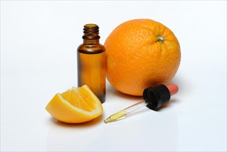Orange and orange oil in bottle with pipette