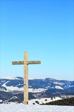 Summit cross of the Belchen in winter with snow