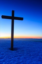 Summit cross of the Belchen with sunset after sunset