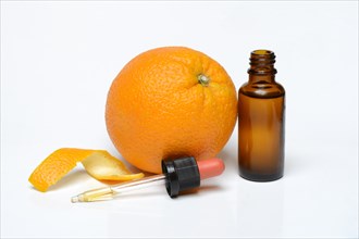 Orange and orange oil in bottle with pipette
