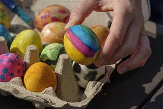 Painted easter eggs in an egg box