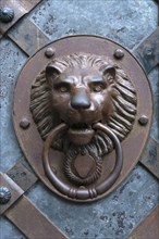 Lion's head as door knocker at the entrance gate of Rabenstein Castle