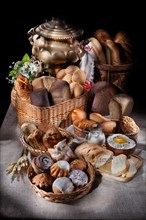 Still life with different kinds of bread in baskets on a tablecloth