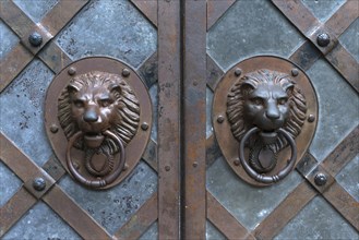 Lion heads as door knockers at the entrance gate of Rabenstein Castle
