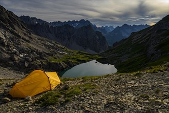 Tent in mountain landscape with Lake Guffelsee and Lechtaler Alps