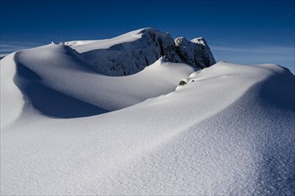 Summit of the Toreck with snow cornices and blue sky