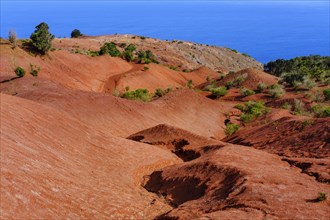 Eroded mountain slope with red earth