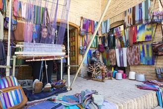 Iranian woman weaving a carpet