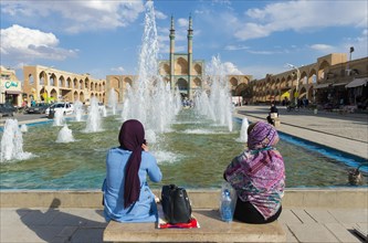 Iranian women sitting in front of Amir Chaqmaq complex