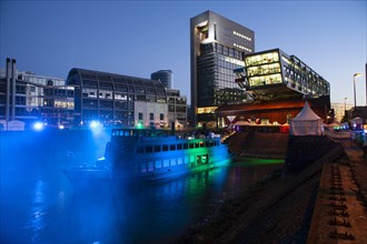 Port of Duesseldorf at night with party ship