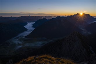 Sunrise over Lechtal Alps with fog in the valley