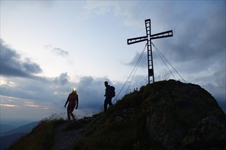 Hikers at dawn on the summit of the Feldalphorn