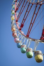 Colorful gondolas in front of a blue sky