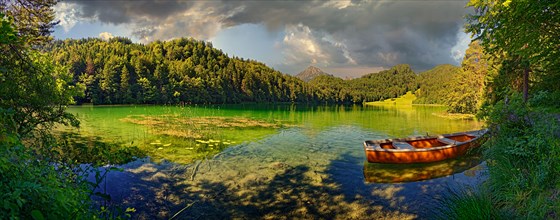 Idyllic Lake Alatsee with rowing boat