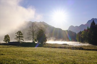 Sunrise with wafts of mist at Lake Geroldsee
