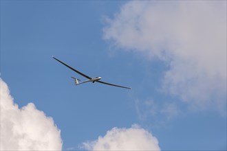 Glider flying in a cloudy sky