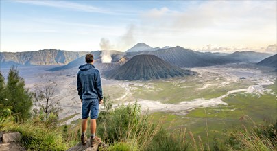 Young man in front of volcanic landscape