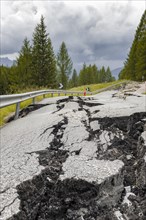 Broken road with cracks in the road surface
