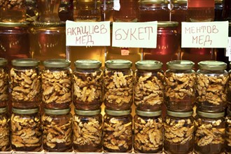 Honey with walnut in jar for sale