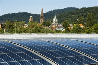 City view with Freiburg Cathedral and photovoltaic plant