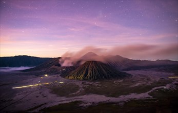 Volcanic landscape at sunrise with starry sky