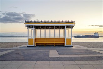 Yellow vintage bus stop by the sea in Portsmouth