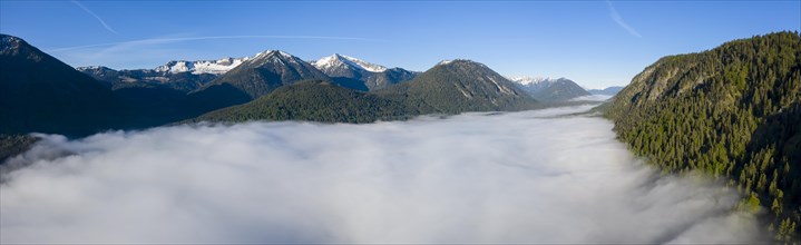 Mountains rising out of high fog over Lake Sylvensteinsee