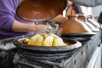 Delicious moroccan tajine prepared and served in clay pots