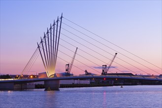 Media City footbridge and victorian cranes in afterglow