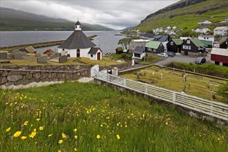 The small village Haldarsvik with the octagonal church and view of the Atlantic Ocean