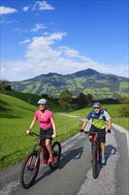 Two cyclists with electric mountain bikes