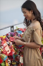 Woman looking at love locks and hearts