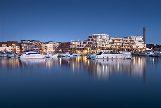 City harbour with modern hotel complex at dusk