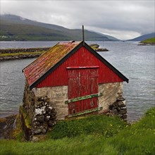 Small fishing hut on the Atlantic Ocean in the small village of Haldarsvik