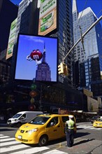 Traffic cop regulates traffic jam at Times Square